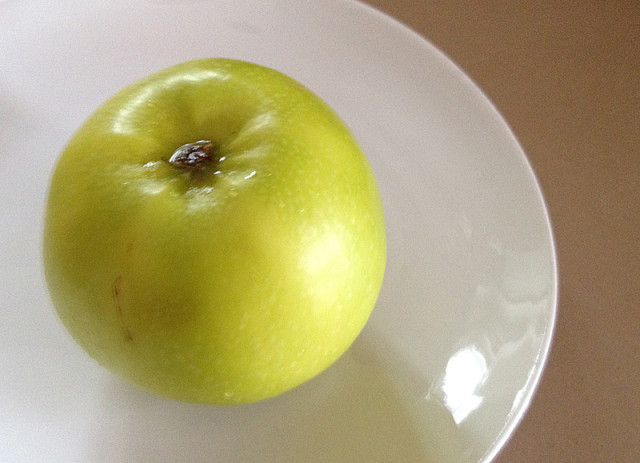 green apple on white plate